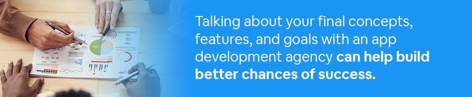 People looking at data together on a table with text: Talking about your final concepts, features, and goals with an app development agency can help build better chances of success. 